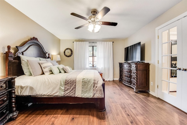 bedroom featuring ceiling fan, light hardwood / wood-style flooring, and french doors