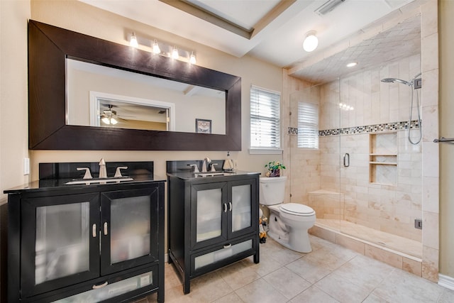 bathroom with walk in shower, vanity, ceiling fan, tile patterned flooring, and toilet