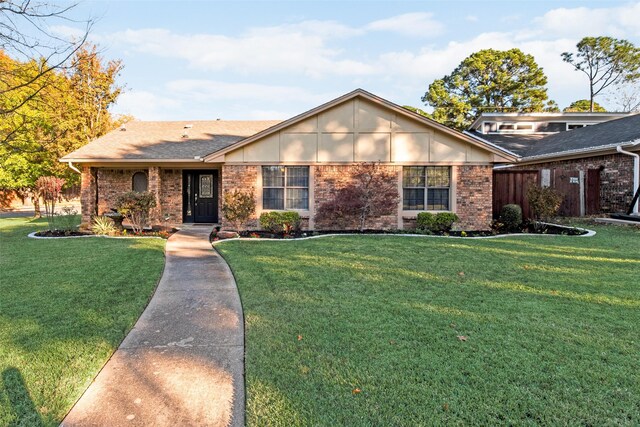 single story home featuring a front lawn