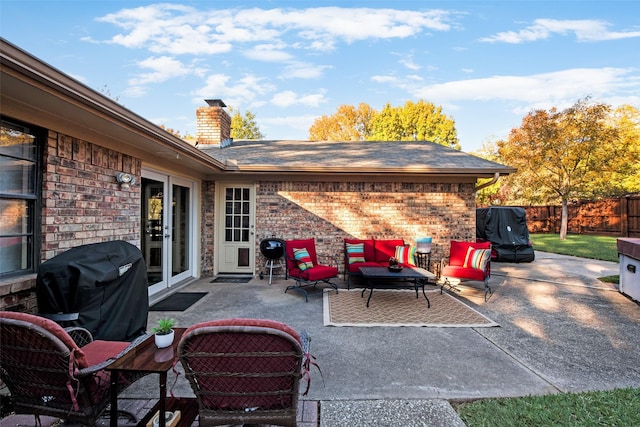 view of patio / terrace with french doors, an outdoor living space, and grilling area