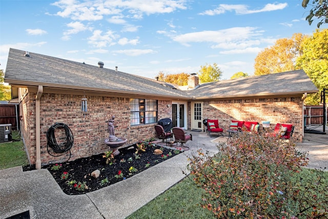 rear view of house featuring a patio area and central AC