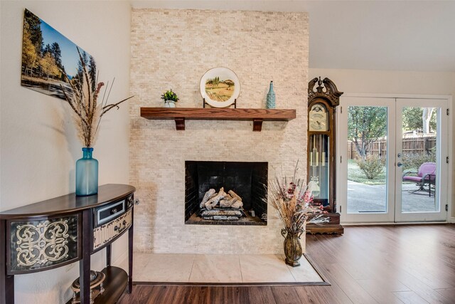 interior space with a fireplace, hardwood / wood-style floors, and french doors