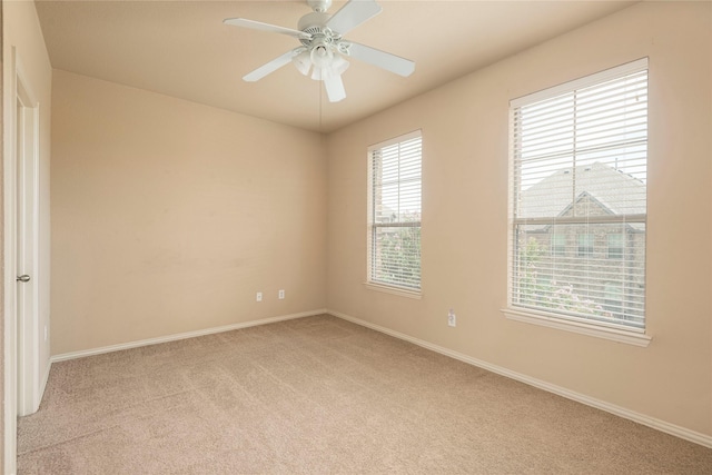 carpeted empty room featuring ceiling fan