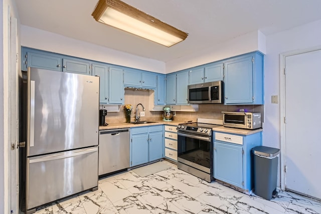 kitchen with blue cabinets, sink, and appliances with stainless steel finishes