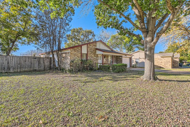 view of front of home featuring a garage and a front lawn