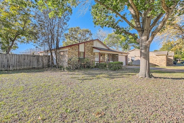 view of front of property with a garage and a front yard