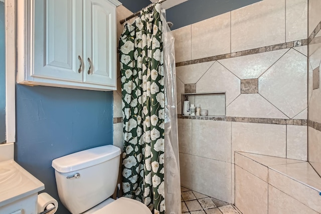 bathroom with curtained shower, vanity, and toilet