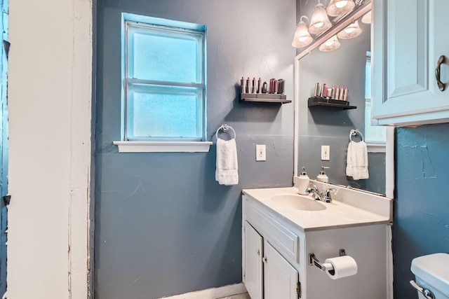 bathroom featuring vanity and toilet