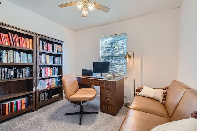 carpeted office space with ceiling fan