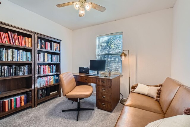 home office with ceiling fan and light carpet