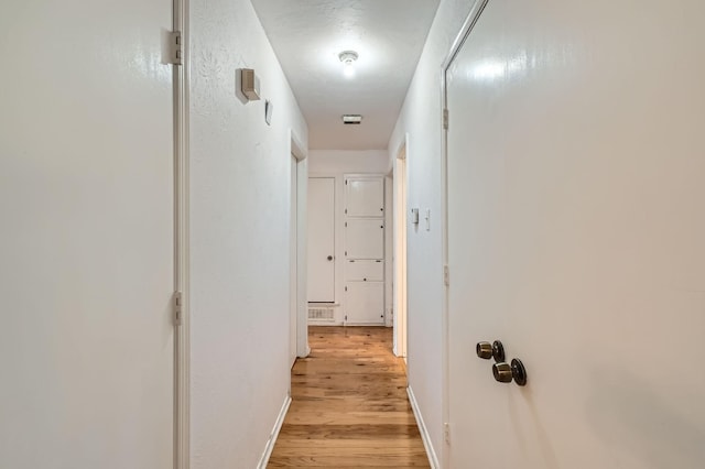 corridor with light wood-type flooring