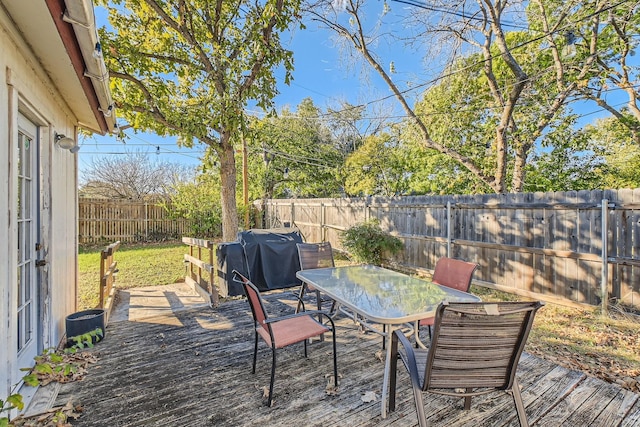 wooden deck with a grill