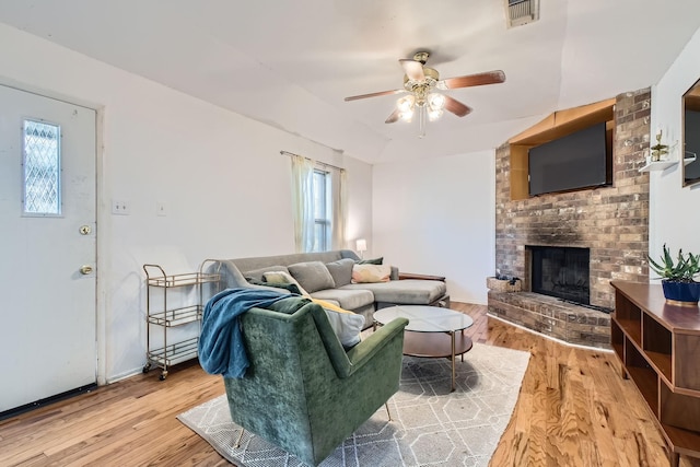 living room featuring plenty of natural light, ceiling fan, and light wood-type flooring