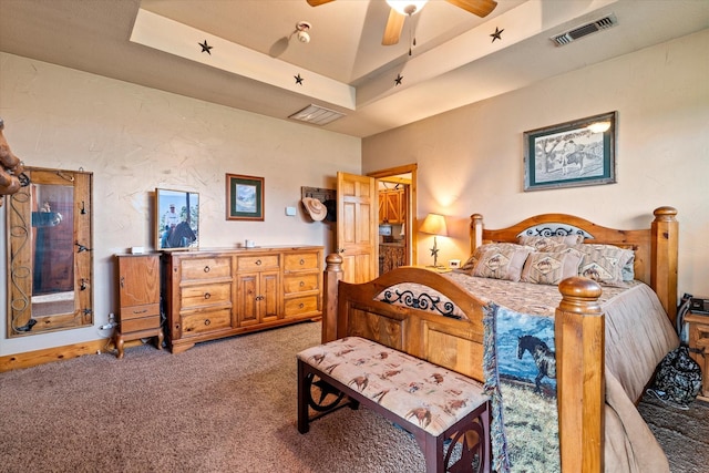 bedroom with carpet, ceiling fan, and a tray ceiling