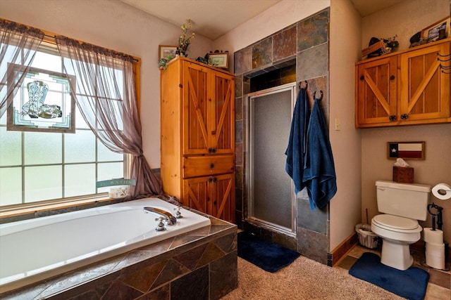 bathroom featuring plenty of natural light, shower with separate bathtub, and toilet