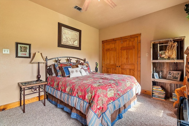 carpeted bedroom with a closet and ceiling fan