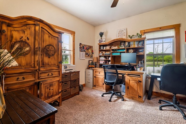 office space with ceiling fan, light colored carpet, and a healthy amount of sunlight