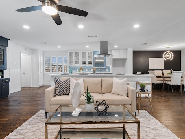 living room featuring dark hardwood / wood-style floors and ceiling fan