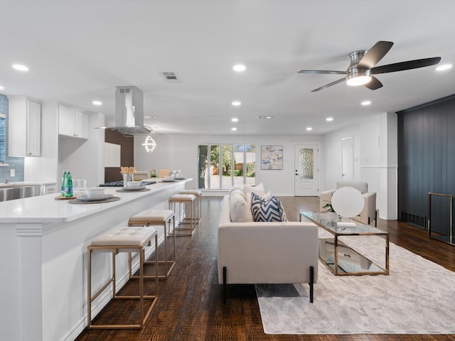 living room with ceiling fan and dark hardwood / wood-style floors