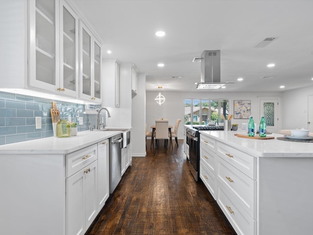 kitchen with white cabinetry, sink, stainless steel appliances, light stone counters, and dark hardwood / wood-style flooring