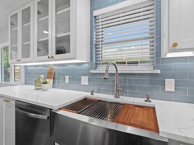 kitchen featuring white cabinets, backsplash, a healthy amount of sunlight, and sink