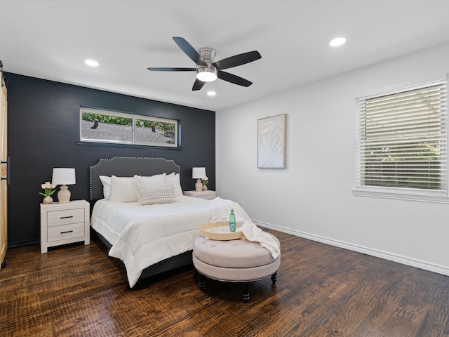 bedroom featuring multiple windows, ceiling fan, and dark hardwood / wood-style flooring