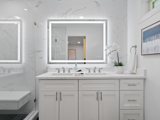 bathroom with vanity and a shower with door