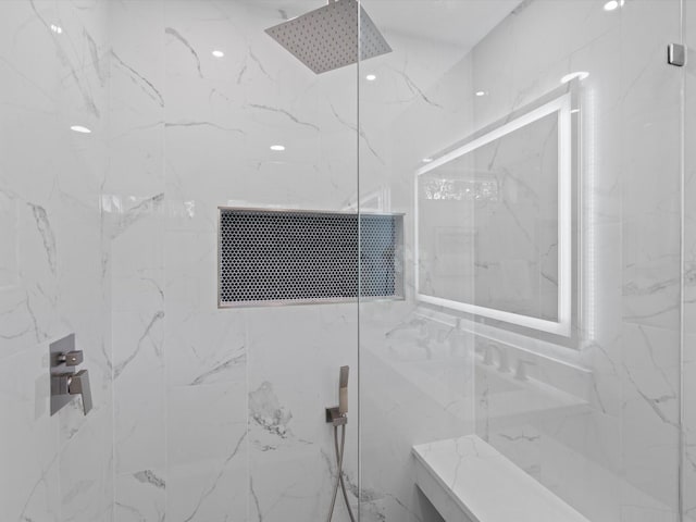 bathroom with a tile shower