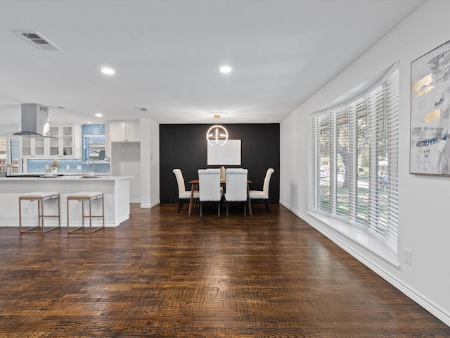 dining space featuring dark hardwood / wood-style flooring and sink