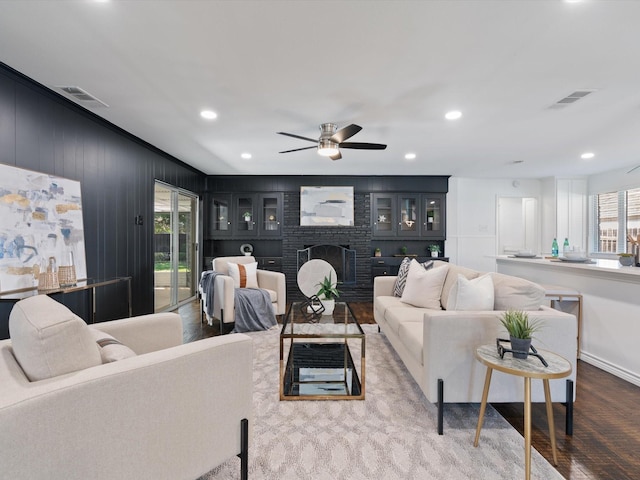 living room featuring a fireplace, hardwood / wood-style flooring, and ceiling fan