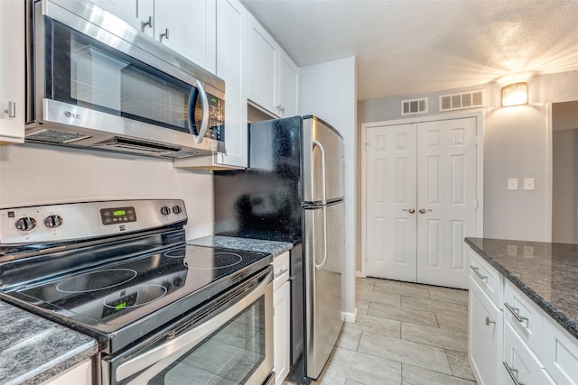 kitchen featuring white cabinetry and stainless steel appliances