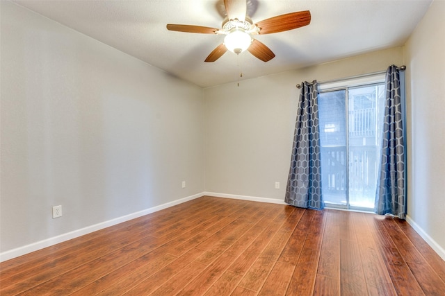 spare room with wood-type flooring and ceiling fan