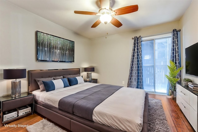 bedroom featuring dark wood-type flooring, ceiling fan, and access to outside