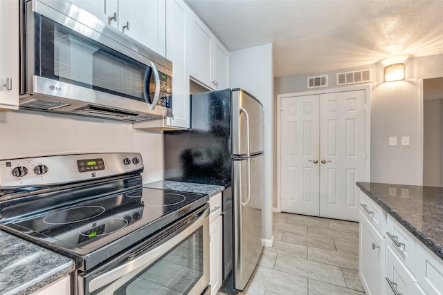 kitchen featuring appliances with stainless steel finishes and white cabinets