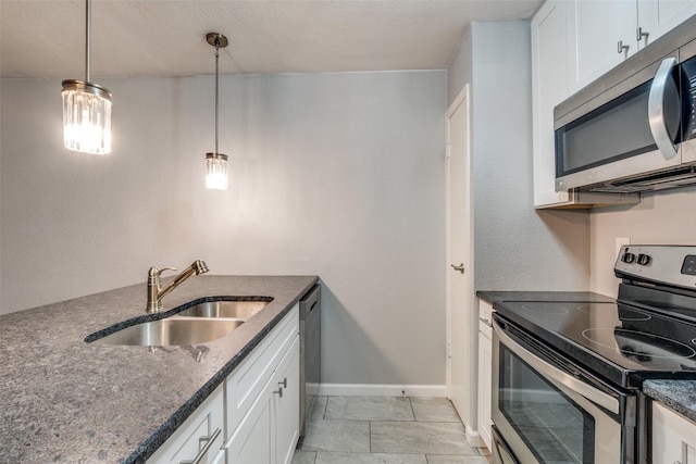 kitchen with appliances with stainless steel finishes, sink, and white cabinets