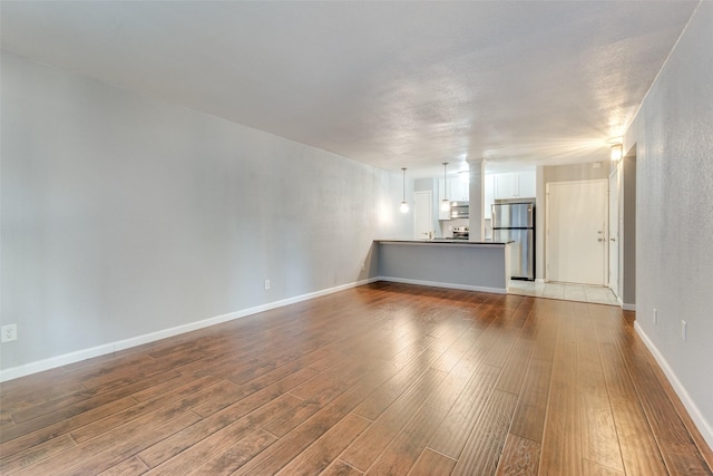 unfurnished living room with hardwood / wood-style flooring