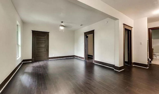 unfurnished room with dark hardwood / wood-style floors and ceiling fan