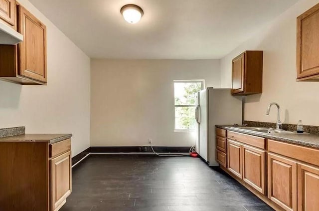 kitchen with sink, white fridge, and dark hardwood / wood-style floors