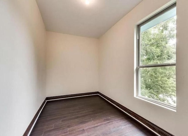 empty room featuring dark hardwood / wood-style flooring