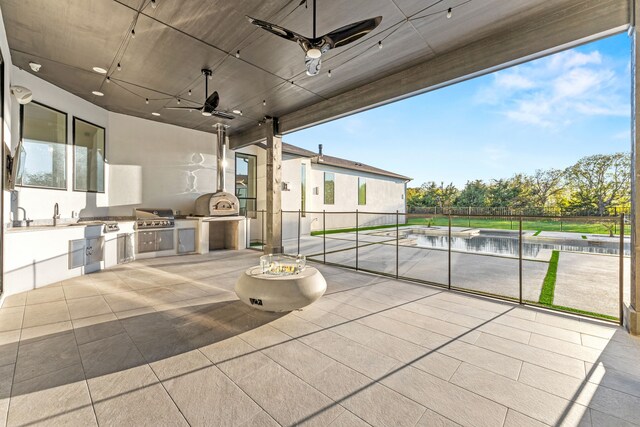 view of patio with area for grilling and ceiling fan