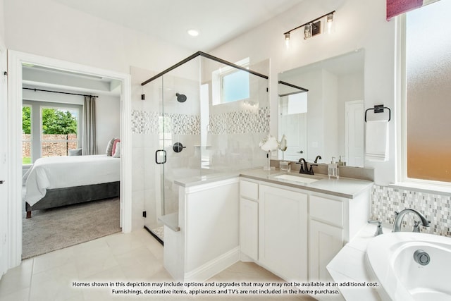 bathroom with independent shower and bath, vanity, plenty of natural light, and tile patterned floors