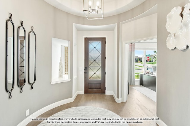 foyer entrance featuring an inviting chandelier and light hardwood / wood-style floors