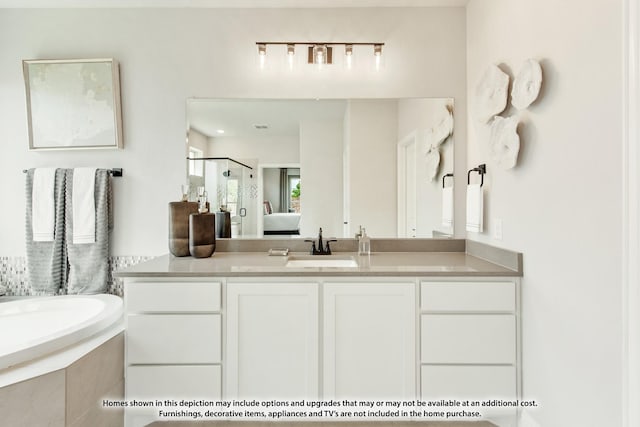 bathroom with vanity and shower with separate bathtub