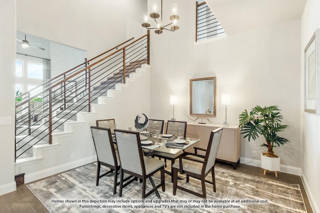 dining room featuring an inviting chandelier, dark hardwood / wood-style floors, and a high ceiling