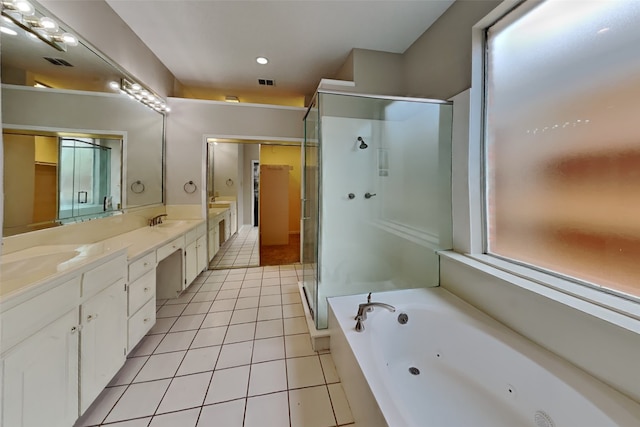 bathroom with vanity, tile patterned flooring, and plus walk in shower