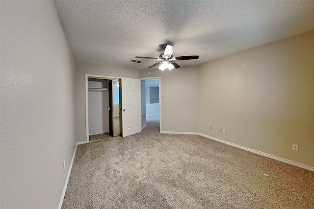 unfurnished bedroom featuring ceiling fan, a closet, carpet, and a textured ceiling