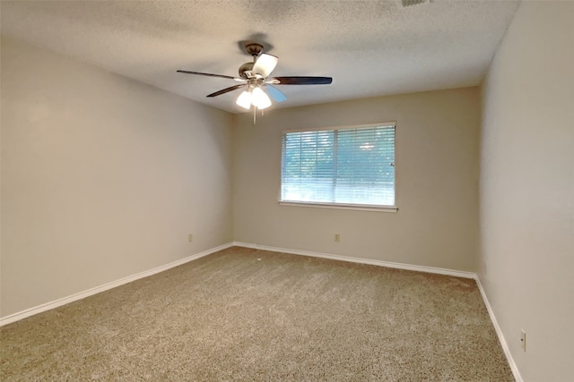 spare room featuring carpet flooring, ceiling fan, and a textured ceiling