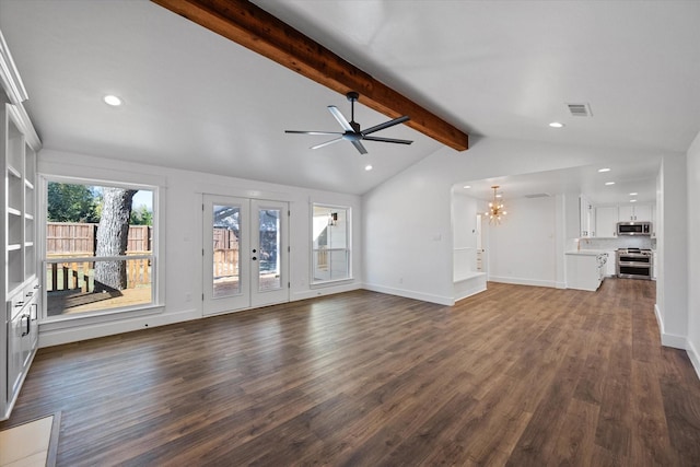 unfurnished living room featuring vaulted ceiling with beams, ceiling fan with notable chandelier, dark hardwood / wood-style floors, and french doors