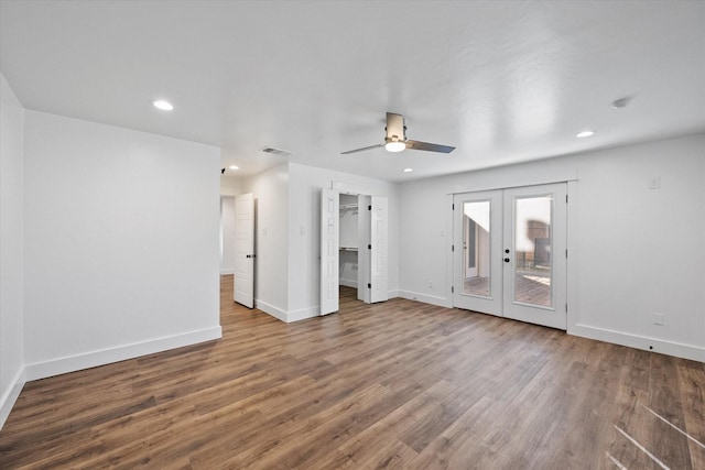 unfurnished living room with hardwood / wood-style flooring, ceiling fan, and french doors