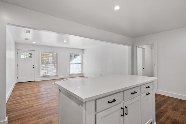 kitchen featuring a center island, white cabinets, and dark hardwood / wood-style floors